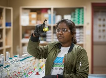 A student working with chemicals in the Lynn Science Center.